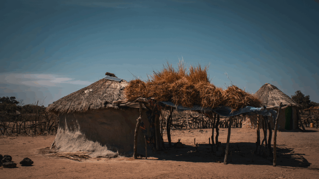 A solar electrified home in rural senegal with a blue sky behind it
